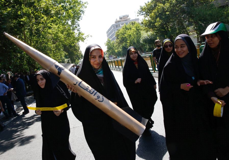 An Iranian girl holds a model of a missile during the al-Quds Day rally in Tehran (photo credit: STRINGER / AFP)