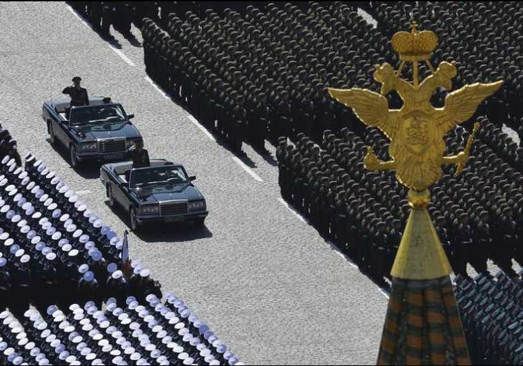 Russian Defense Minister Sergei Shoigu (standing in the first car) and Colonel-General Oleg Salyukov
