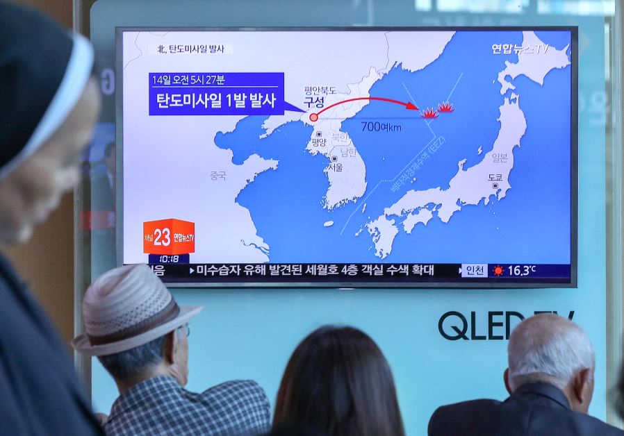 People watch a news report on North Korea firing a ballistic missile, at a railway station in Seoul,