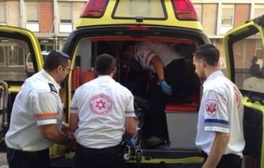 MDA paramedics evacuating woman to hospital in Jerusalem.