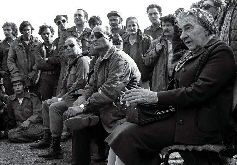 Then-prime minister Golda Meir (R) and her defense minister, Moshe Dayan, meet with Israeli soldiers