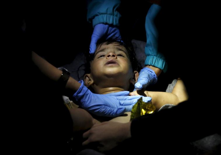 Volunteer doctors and paramedics try to revive a baby