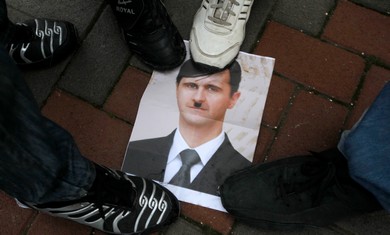 Israeli Arabs step on a picture of Assad as Hitler.