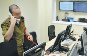 An officer speaks on the phone at the new IDF cyber-defense control center.