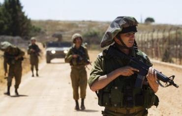  An IDF Lieutenant-Colonel (front) and comrades during a patrol along Israel's border with Lebanon.