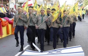 Hezbollah youth stomp on Israeli flag