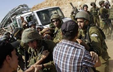 Soldiers scuffle with Palestinians in the West Bank.