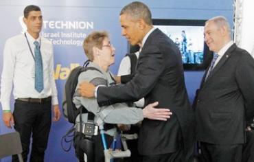 US President Barack Obama hugs paralyzed US Army Sgt. (res.) Theresa Hannigan during his March visit