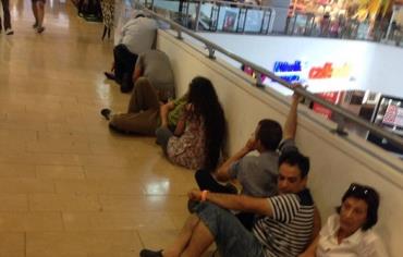 People at Dizengoff Center waiting for the all clear