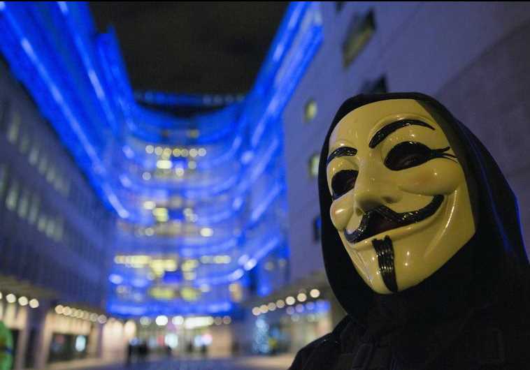 A supporter of the activist group Anonymous wears a mask during a protest against the BBC