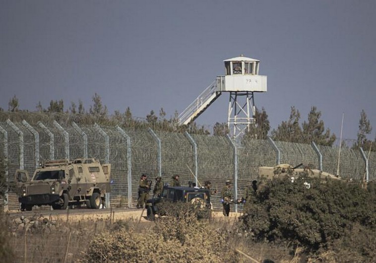 Israeli soldiers stand near the border with Syria in the Golan Heights (credit: REUTERS)