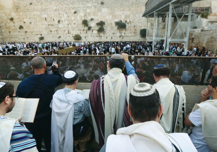 Men of the Women of the Wall pray behind the partition at the back of the women&rsquo;s section, in 2013.