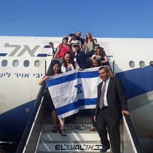 Zeev Elkin welcomes olim on the 53rd Nefesh B'Nefesh flight as it lands in Israel (credit: STEVE LINDE)