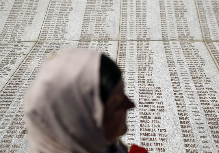 A woman stands in front of the Memorial Center during a reburial ceremony of 136 newly identified victims in Potocari, near Srebrenica, Bosnia and Herzegovina (credit: REUTERS)