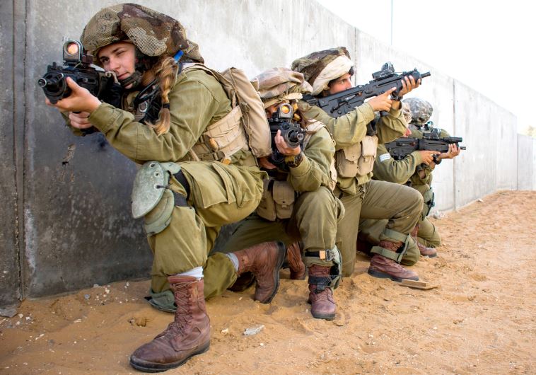 Female combat soldiers in the mixed-gender Caracal Battalion train in urban warfare. (credit: IDF SPOKESMAN’S UNIT)
