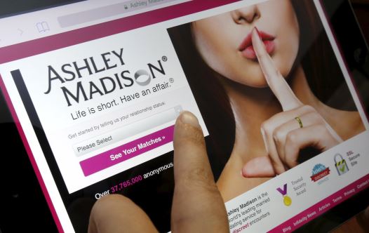 The homepage of the Ashley Madison website is displayed on an iPad, in this photo illustration (credit: REUTERS)