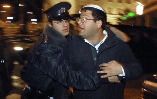 A policeman arrests Israeli right-wing activist Itamar Ben Gvir during a 'Peace Now' demonstration in Jerusalem (credit: GALI TIBBON / AFP)