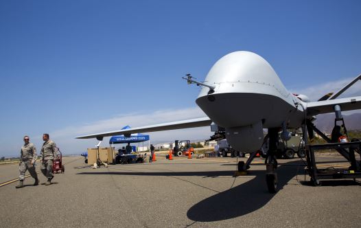 A General Atomics MQ-9 Reaper stands on the runway during ''Black Dart'', a live-fly, live fire demonstration of 55 unmanned aerial vehicles (credit: REUTERS)