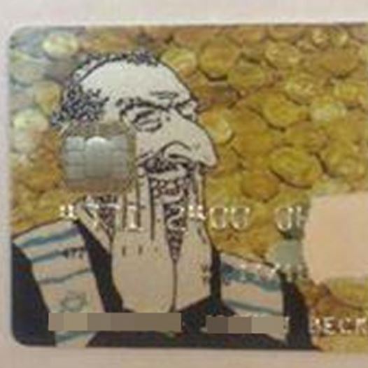 An anti-Semetic credit card features a hook-nosed Jew, laughing gleefully against a backdrop of gold coins  (credit: Courtesy)