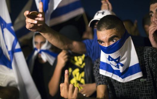 A right-wing Israeli activist gestures during a counter-protest against supporters of hunger-striking Palestinian detainee Mohammed Allan (credit: REUTERS)