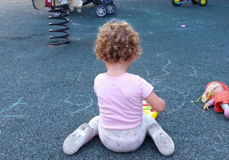 A toddler at a playground in Tel Aviv
