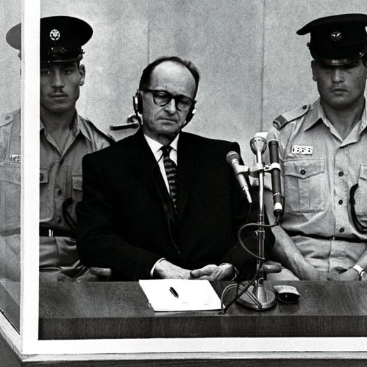 Israeli police flank Adolf Eichmann, the Nazi SS colonel who headed the Gestapo's Jewish Section and was responsible for millions of Jews' deaths in Nazi concentration camps, as he stands trial inside a bulletproof booth in a Jerusalem courtREUTERS