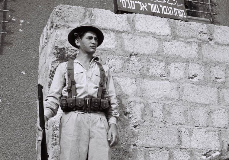 A JEWISH solider stands guard outside a building days after the British Mandate ended in 1948 (credit: REUTERS)