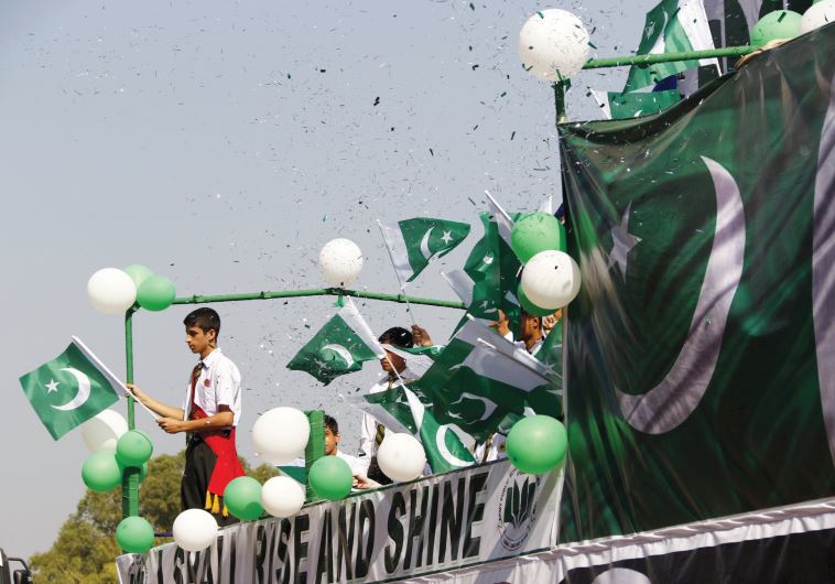 PEOPLE WAVE Pakistani flags at a rally earlier this year. (credit: REUTERS)