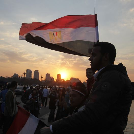 People stand on a bridge overlooking the river Nile as many Egyptians walk on the streets with Egyptian flags in Cairo (credit: REUTERS)