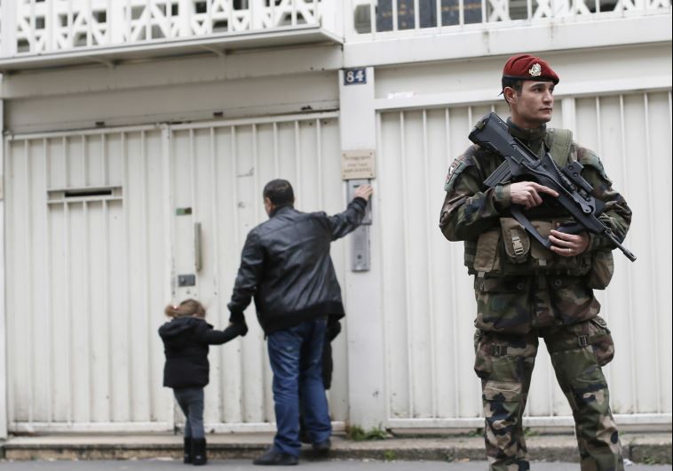 A French soldier secures the entrance to a Jewish school in Paris after the Charlie Hebdo and Hyper Cacher terrorist attacks last January (credit: REUTERS)