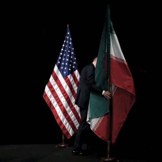 A staff member removes the Iranian flag from the stage during the Iran nuclear talks in Vienna, Austria July 14, 2015 (credit: REUTERS)