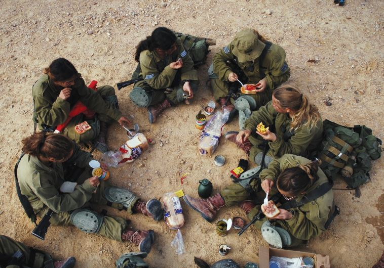 SOLDIERS SIT for a shared meal during training. IDF regulations are supposed to favor lone soldiers in giving them extra time to complete errands outside the army, but some say that this is not being honored. (credit: LONE SOLDIER CENTER IN MEMORY OF MICHAEL LEVIN)