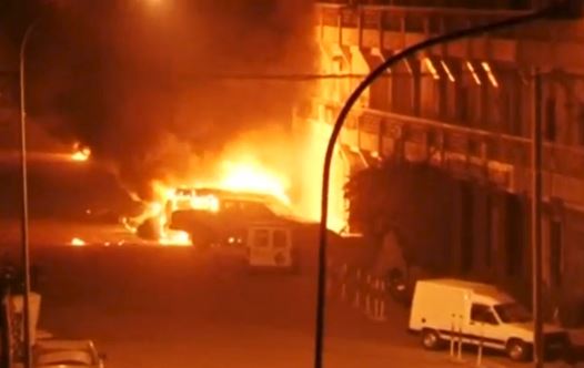 A view shows vehicles on fire outside Splendid Hotel in Ouagadougou, Burkina Faso in this still image taken from a video January 15, 2016