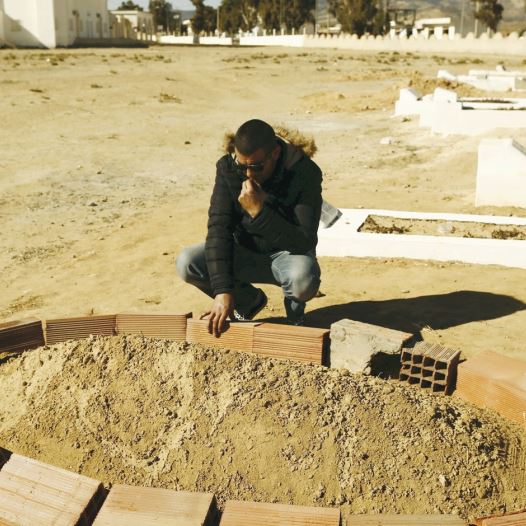 Five years after Tunisia’s Arab Spring, an unemployed graduate, Rabie Gharssali, visits the grave of his friend, Ridha Yahyaoui, who killed himself after being refused a job (credit: REUTERS)