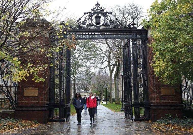 STUDENTS WALK on the campus of a university in Connecticut