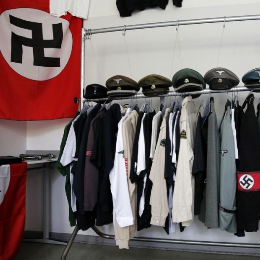 Nazi uniforms and a Swastika flag that were confiscated by the Berlin police during raids against German neo-Nazis (credit: REUTERS)