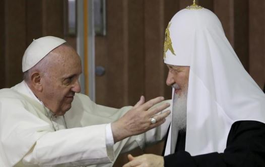 Pope Francis, left, reaches to embrace Russian Orthodox Patriarch Kirill after signing a joint declaration at the Jose Marti International airport in Havana, Cuba, Friday, February 12, 2016.