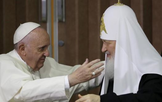 Pope Francis, left, reaches to embrace Russian Orthodox Patriarch Kirill after signing a joint declaration at the Jose Marti International airport in Havana, Cuba, Friday, February 12, 2016. (Credit: GREGORIO BORGIA/POOL/REUTERS)