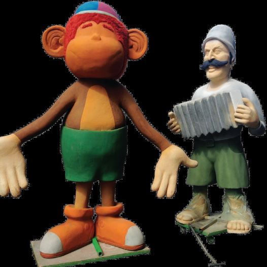 Zionist pioneer character Jacek from ‘Zehu Zeh,’ standing next to Kofiko the monkey from the children’s series of the same name (credit: ARIK LEFFLER)