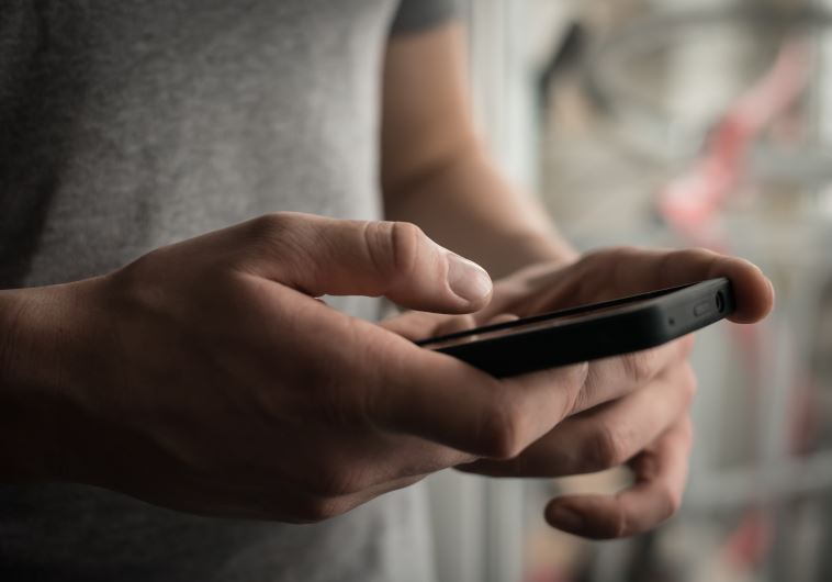 Close up of a man using mobile smart phone