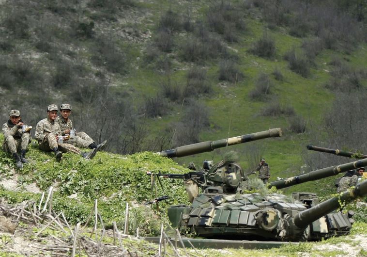 SERVICEMEN OF the army of Nagorno-Karabakh rest at their positions near the village of Mataghis, yesterday. (credit: REUTERS)
