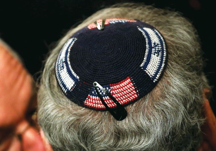 A man wears a kippa embroidered with US and Israeli flags (credit: REUTERS)