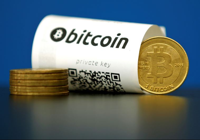 A Bitcoin (virtual currency) paper wallet with QR codes and a coin are seen in an illustration picture taken at La Maison du Bitcoin in Paris, France, May 27, 2015 (credit: REUTERS)