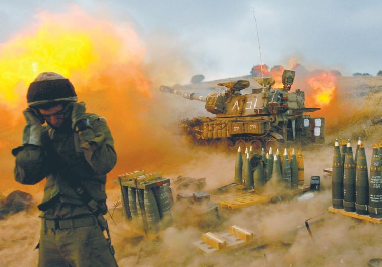 AN ISRAELI soldier stands near a mobile artillery unit as it fires a shell into southern Lebanon on July 13, 2006, a day after IDF reservists Ehud Goldwasser and Eldad Regev were abducted by Hezbollah