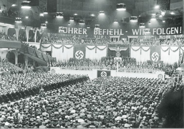 Germans take part in a mass Nazi rally in the Berlin Sports Palace in June 1943