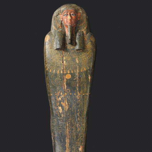 The lid of the mummy&rsquo;s coffin sports characteristic ancient Egyptian stylized facial features and informative hieroglyphics