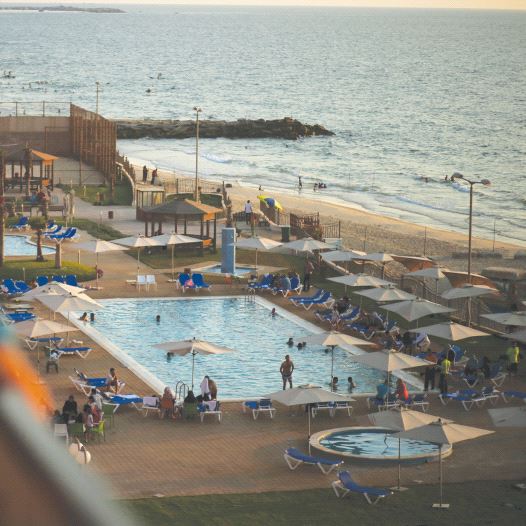 Palestinians are seen at the Blue Beach Resort in Gaza shortly after it opened in July 2015 (credit: MOHAMMED SALEM/REUTERS)