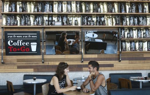 A couple relax at a branch of Aroma in Tel Aviv, one of Israel’s most successful coffee chains