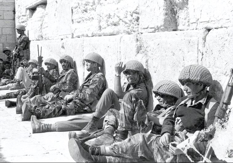IDF Paratroopers relax after liberating the Western Wall during the Six Day War (credit: IDF SPOKESMAN’S UNIT)
