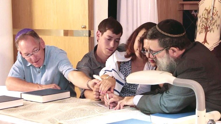 Writing in the final letters of the restored Torah in Santa Fe, New Mexico in 2014